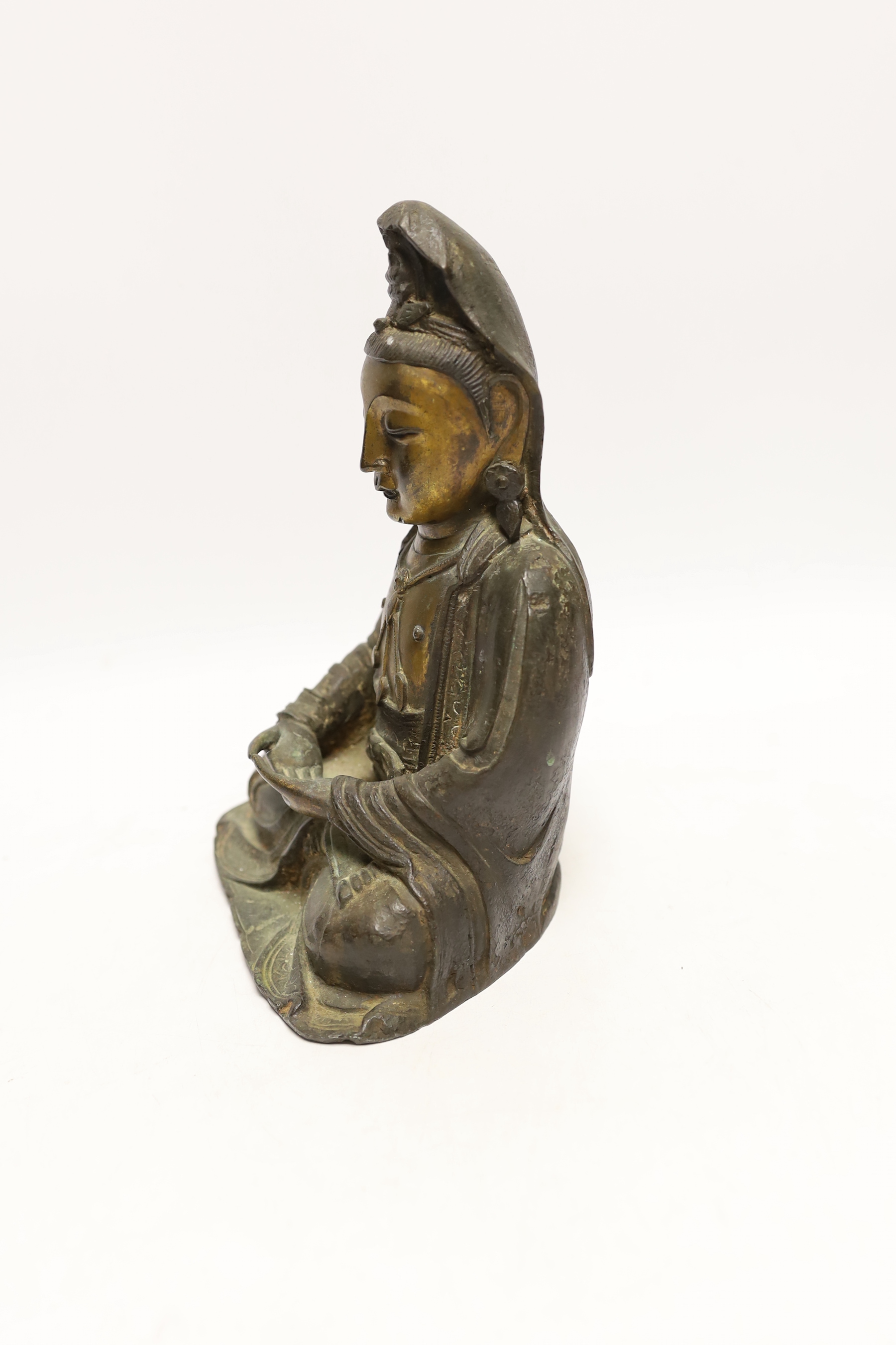 A Chinese Ming gilt bronze figure of Xi Wangmu, Queen Mother of the West, late 16th / early 17th century, Provenance: bought from the 50th Chelsea Antiques Fair, R & D Coombes, 1980, 24cm high